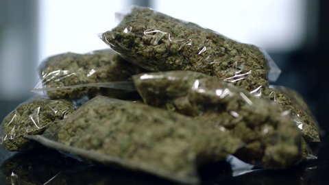 ounce bags of cannabis on table close-upficus rack