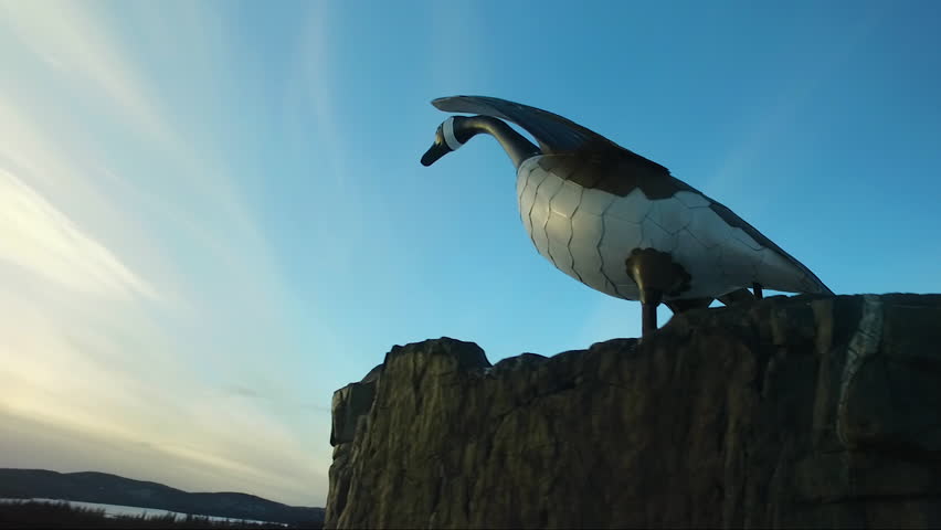 Flying past a statue of a goose at sunset over a scenic lookout in Northern Ontario