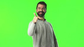Man with thumb up on green screen chroma key