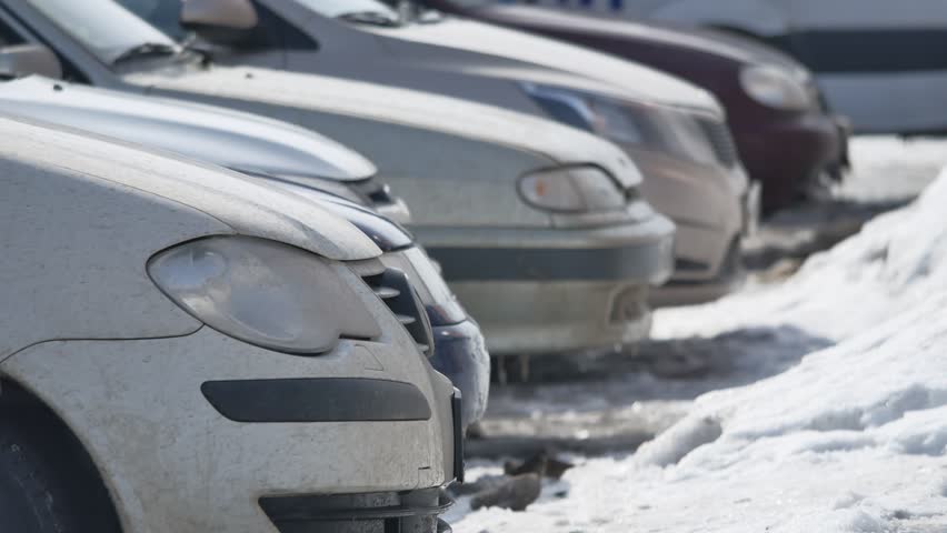 cars in the Parking lot in the winter under the snow