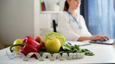 Vegetable diet nutrition and medication concept. Nutritionist consulting patient. Nutritionists workplace
