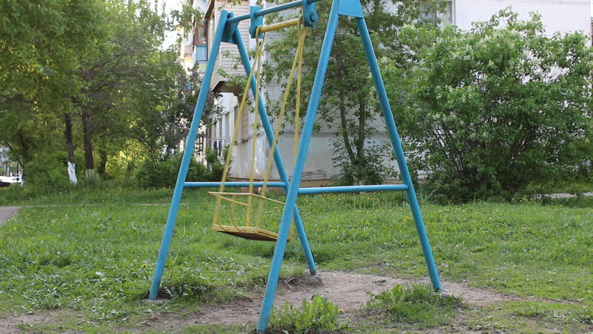Blue swing swinging with nobody