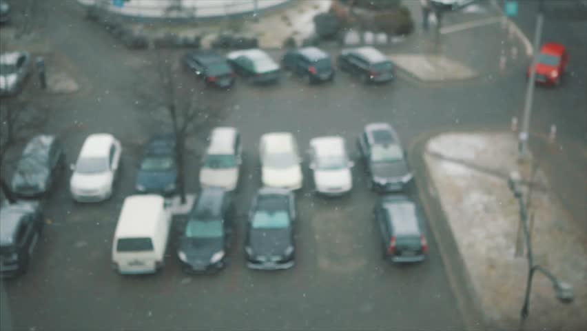 Warsaw winter. The street of the city is illuminated by flashlights. Offices in glass skyscrapers are beautifully illuminated.  cityscape. Winter evening, cars are standing at a traffic light.