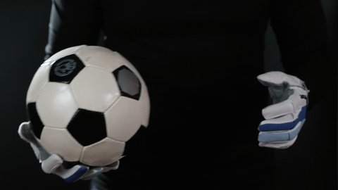 close up goalkeeper holding soccer ball in the stadium studio football player hands professional