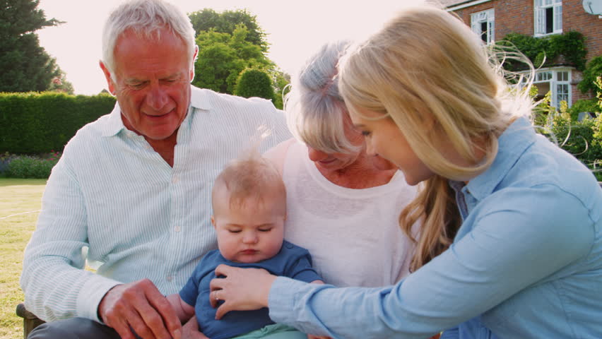 Grandparents Sit Outdoors With Baby Grandson And Adult Daughter | Shutterstock HD Video #1008754724