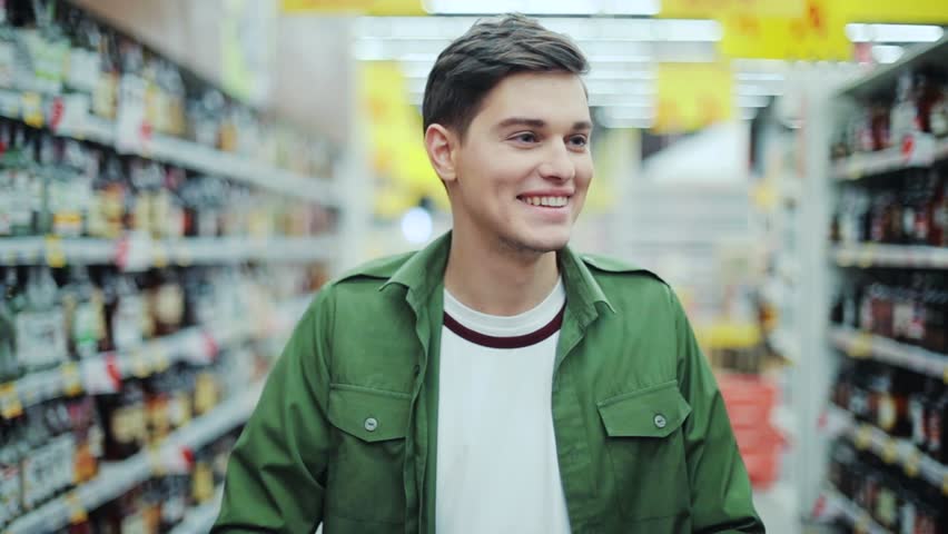 Close up smiling man walk with shopping cart at the supermarket feel happy hypermarket hand food shop store customer grocery handsome indoor lifestyle male market buyer guy product shopper slow motion Royalty-Free Stock Footage #1008755315