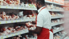 African american sales consultant puts ham on the shelf at a supermarket supermarket market retail happy salesperson store apron black food seller looking shop grocery holding job organic market staff - Powered by Shutterstock - Get 15% off with code: PIKWIZARD15