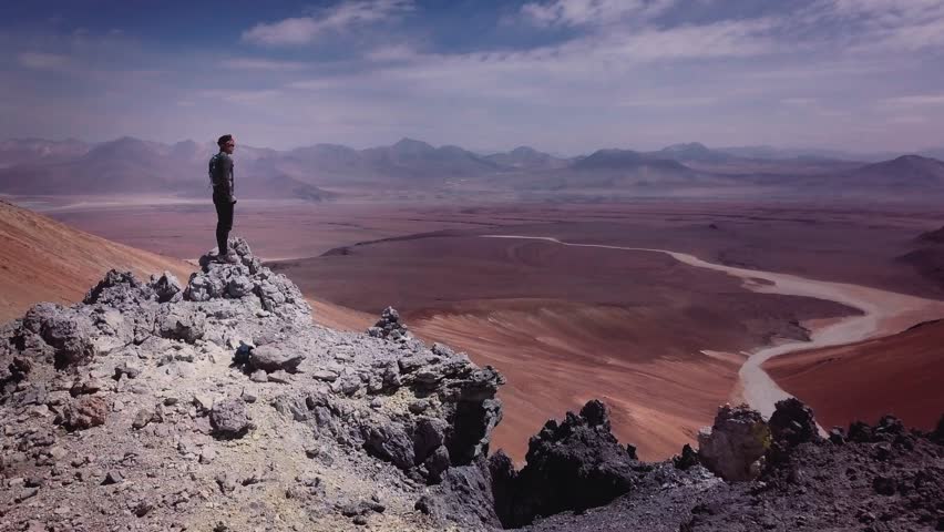 Male trail-runner on summit of the volcano Toco on Atacama desert, 4k. Aerial view of a man running down of a volcano peak. Royalty-Free Stock Footage #1008766358