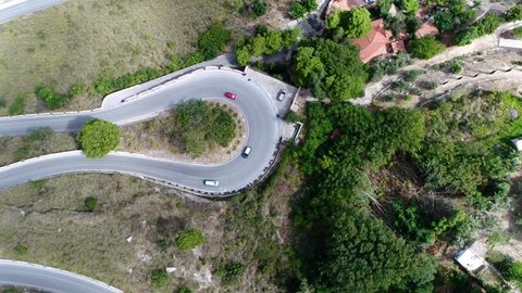 Aerial top down view of hairpin turn also called hairpin bend hairpin corner named for its resemblance to a hairpin bobby pin is bend in a road with a very acute inner angle vehicles driving over road
