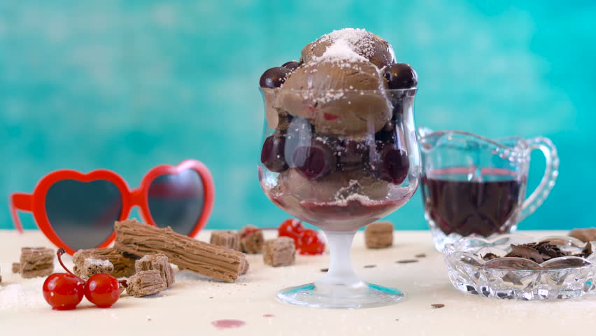 Making summertime gourmet chocolate cherry and coconut ice cream sundae.