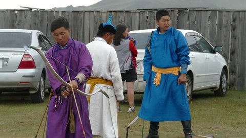 Telmen-sum, Mongolia - July 15, 2017: National Mongolian holiday Naadam and archery. A man takes aim and shoots.