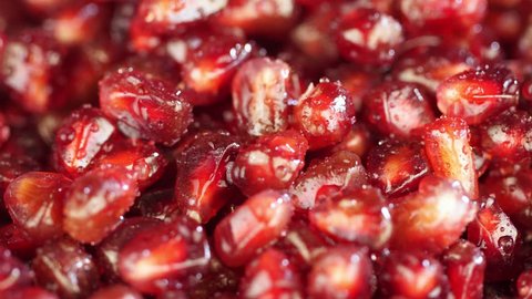 Bright juicy pomegranate. Pomegranate grains on a white background. Macro. macro shooting. juicy. Red grains of pomegranate close up. Beautiful fresh pomegranate. 