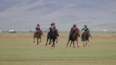 Telmen sum, Mongolia - July 15, 2017: Mongolian national holiday Naadam. Races of children on horses.
