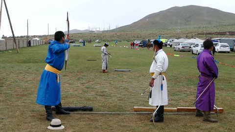 Telmen-sum, Mongolia - July 15, 2017: National Mongolian holiday Naadam and archery. A man takes aim and shoots. 