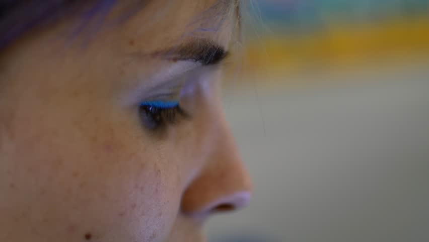 A woman is looking into the phone, close-up of a face.