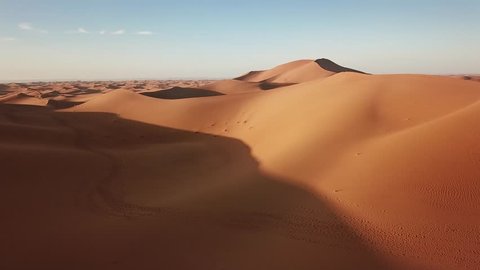 Aerial view on sand dunes in Sahara desert at sunrise, Africa, 4k