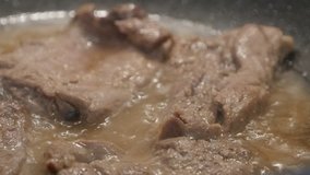 Frying pan with pork cuts close-up 4K 2160p 30fps UltraHD footage - Preparing meat in hot oil 3840X2160 UHD video