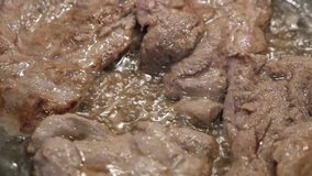 Meat preparing in hot oil close-up 1920X1080 HD footage - Deep frying in wok of  pork cuts  slow motion 1080p FullHD video