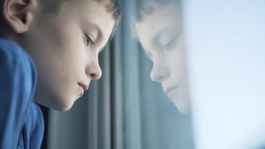 the boy is sad looking out the window Royalty-Free Stock Footage #1008787112