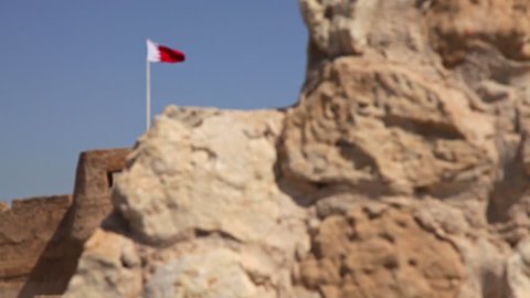 Muharraq, CIRCA June 2017: Arad Fort. Ancient wall and Flag. Camera Movement. Bahrain.
