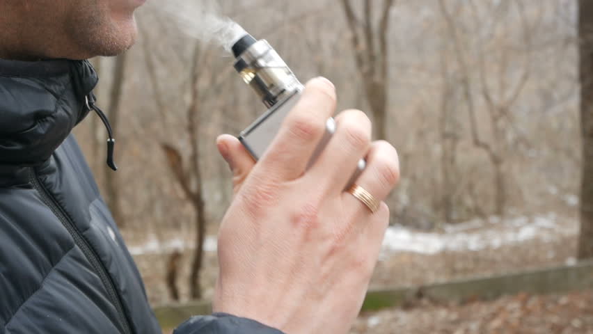 Smoking man on the wall and nature