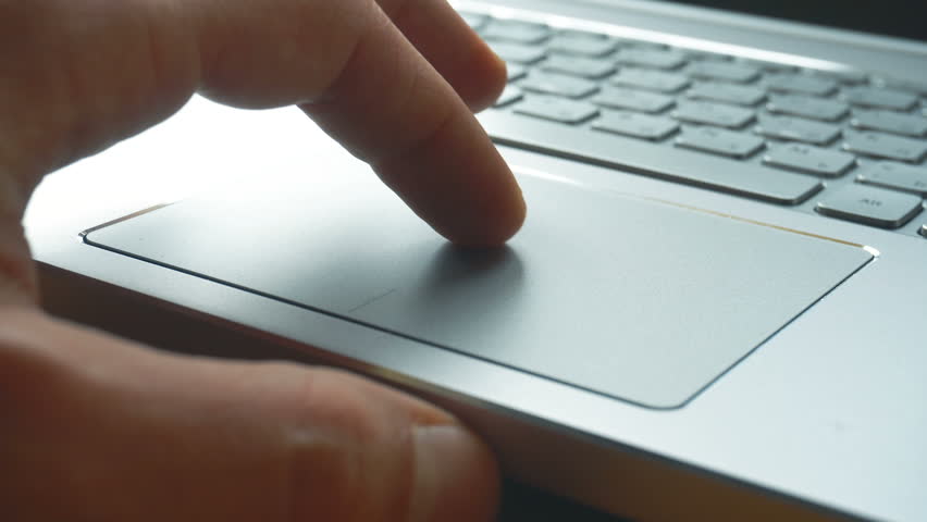 Laptop keyboard. Close up shot of man scrolling a Website Using Laptop Track Pad Royalty-Free Stock Footage #1008793376