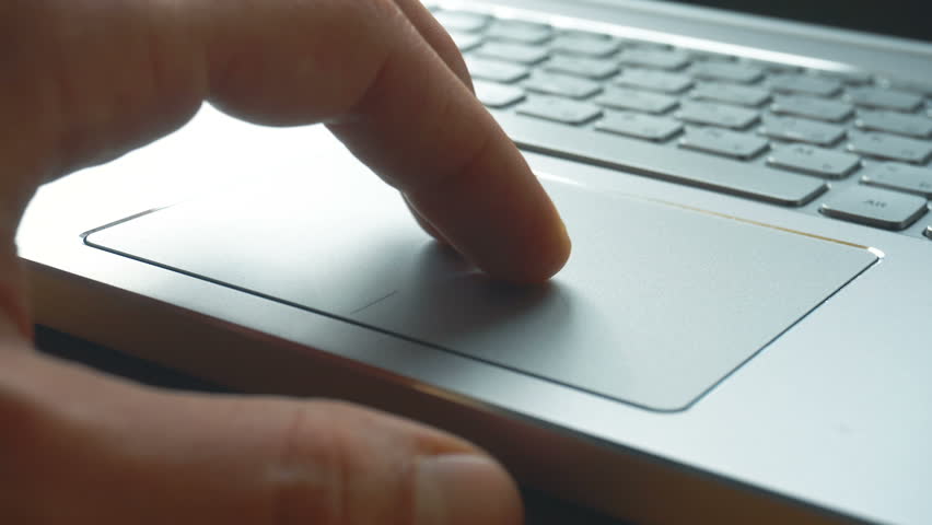 Laptop keyboard. Close up shot of man scrolling a Website Using Laptop Track Pad Royalty-Free Stock Footage #1008793376