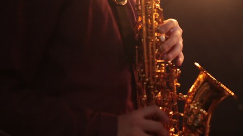 Little boy playing the saxophone.