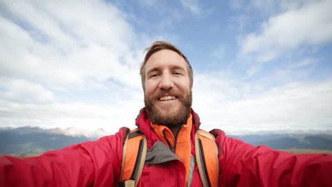 Man hiking in Canada takes a selfie on a mountain trail surrounded by nature, Young man hiker taking selfies with 360 degree mountain views 