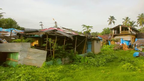 Precarious shacks in rural green area in Anjuna, Goa. Poor humble houses in India. Third world concept