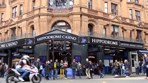 LONDON, ENGLAND, UNITED KINGDOM - APRIL, 2017: London city centre center street corner building Hippodrome Casino and crowds of people passing by during day time