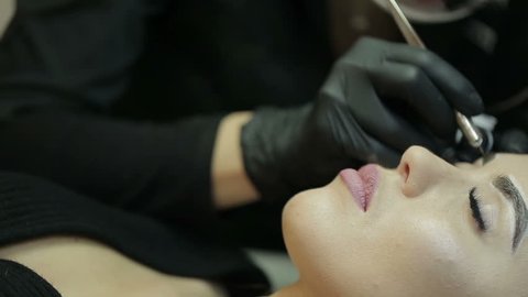 Microblading procedure. Master works with the eyebrows.