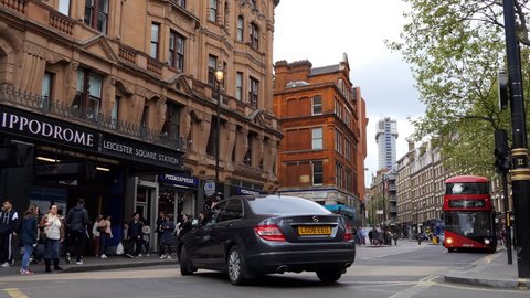 LONDON, ENGLAND, UNITED KINGDOM - APRIL, 2017: Historical London city centre center, Charring Cross road full of tourists, black taxi cabs