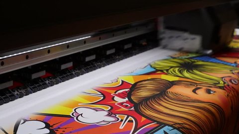 Industrial printing on woven material, modern digital inkjet printer puts a picture on a cloth canvas