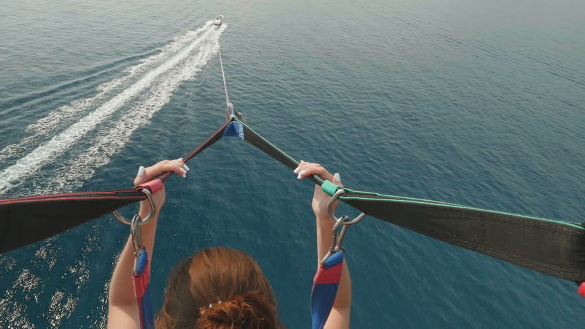 Parasailing water amusement. Flying on a parachute behind a boat in Montenegro