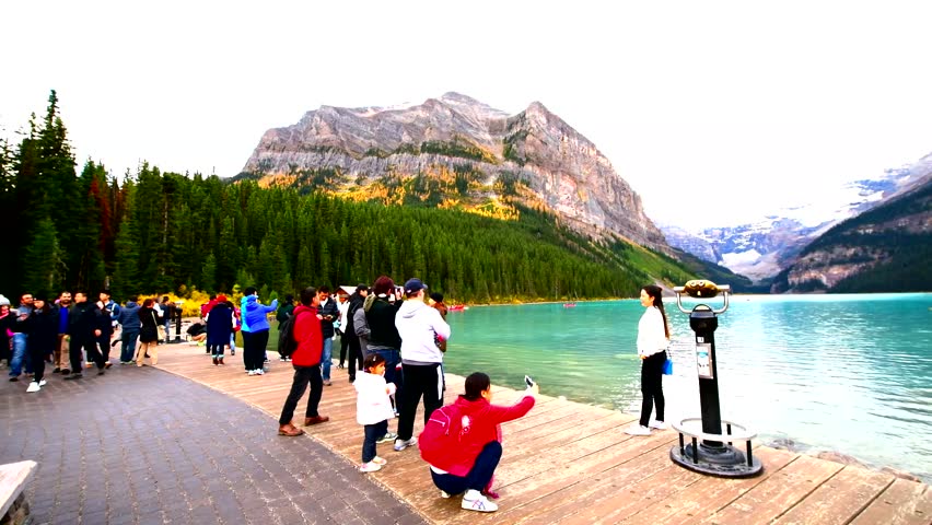 LAKE LOUISE, CANADA -OCT 1, 2017: Large group of tourist watching view lake Louise from Fairmount Hotel. Lake Louise is the second most-visited destination in the Banff National Park.