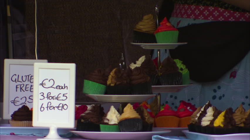 Close up shot of a gluten free cupcake stand at a market.