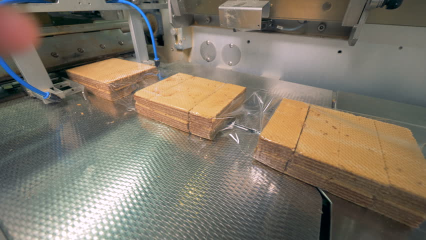 Close up of waffles getting enwrapped and the packs getting separated from each other | Shutterstock HD Video #1008826148