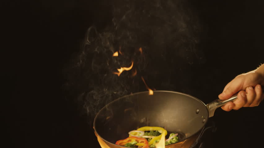 Chef Frying vegetables on fire throwing them in a frying pan Royalty-Free Stock Footage #1008828392