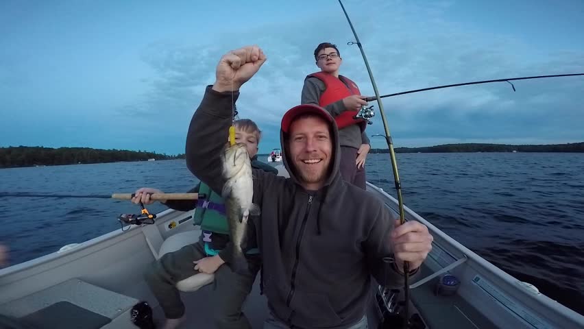 man and his catfish he caught with kids in boat Royalty-Free Stock Footage #1008834698