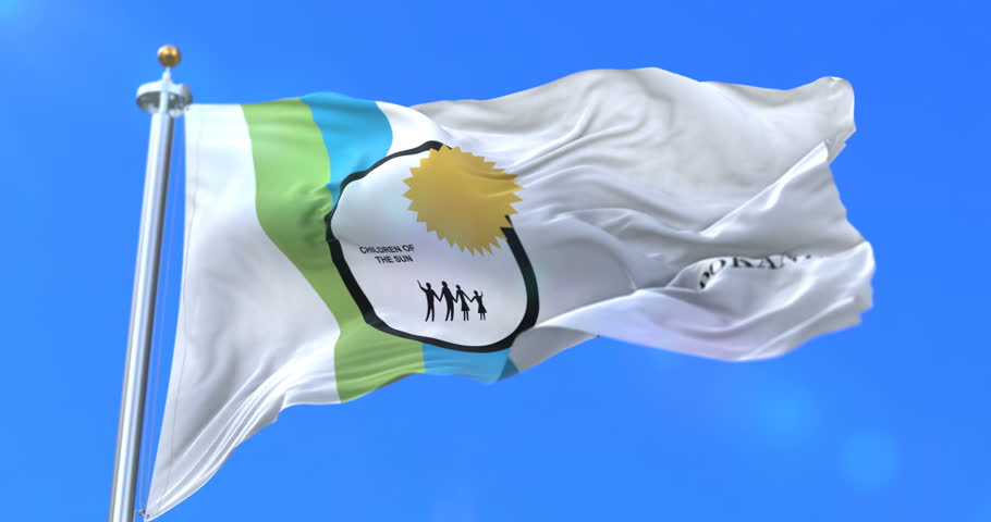 Spokane city flag, city of Washington in USA or United States of America, waving at wind in blue sky, slow - loop