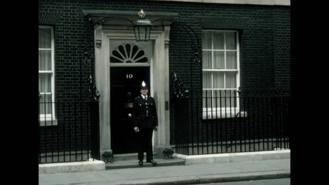 London, United Kingdom - 1978: A police officer stands guard outside 10 Downing Street. 

