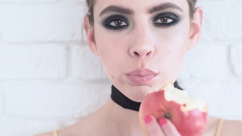Girl biting fresh apple. Girl with apples. emotions. Attractive young woman eating apple. Fashion girl with apple. Juicy aplle.