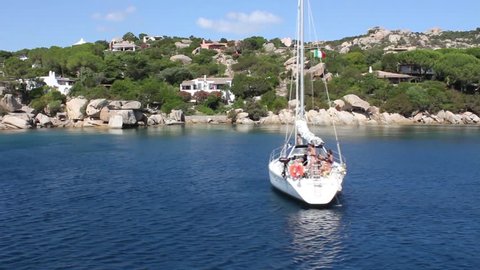 Beautiful coastline of sardinia with sailing ship
