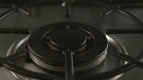 Slow motion clip of a gas hob being lit