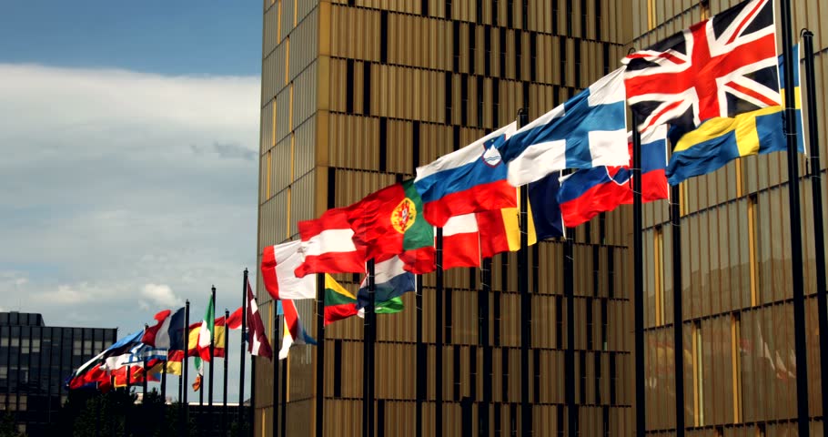 EU flags with flag of the UK are weaving on the wind in front of the Cour de justice de l'Union européenne (Court of Justice of the European Union) in Luxembourg  Royalty-Free Stock Footage #1008864671