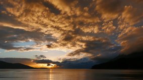 A colorful sunset video facing the entrance of Gulf of Gokova (Aegean Sea) with fiery clouds. Shot from Akyaka beach in autumn.
