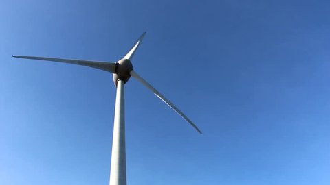 Wind turbine against a bright blue sky