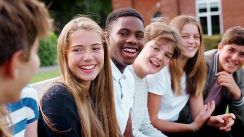 Group Of Teenage Students Socializing Outside School Buildings