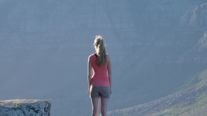 Young adult woman looking at view of Cape Town South Africa at sunset